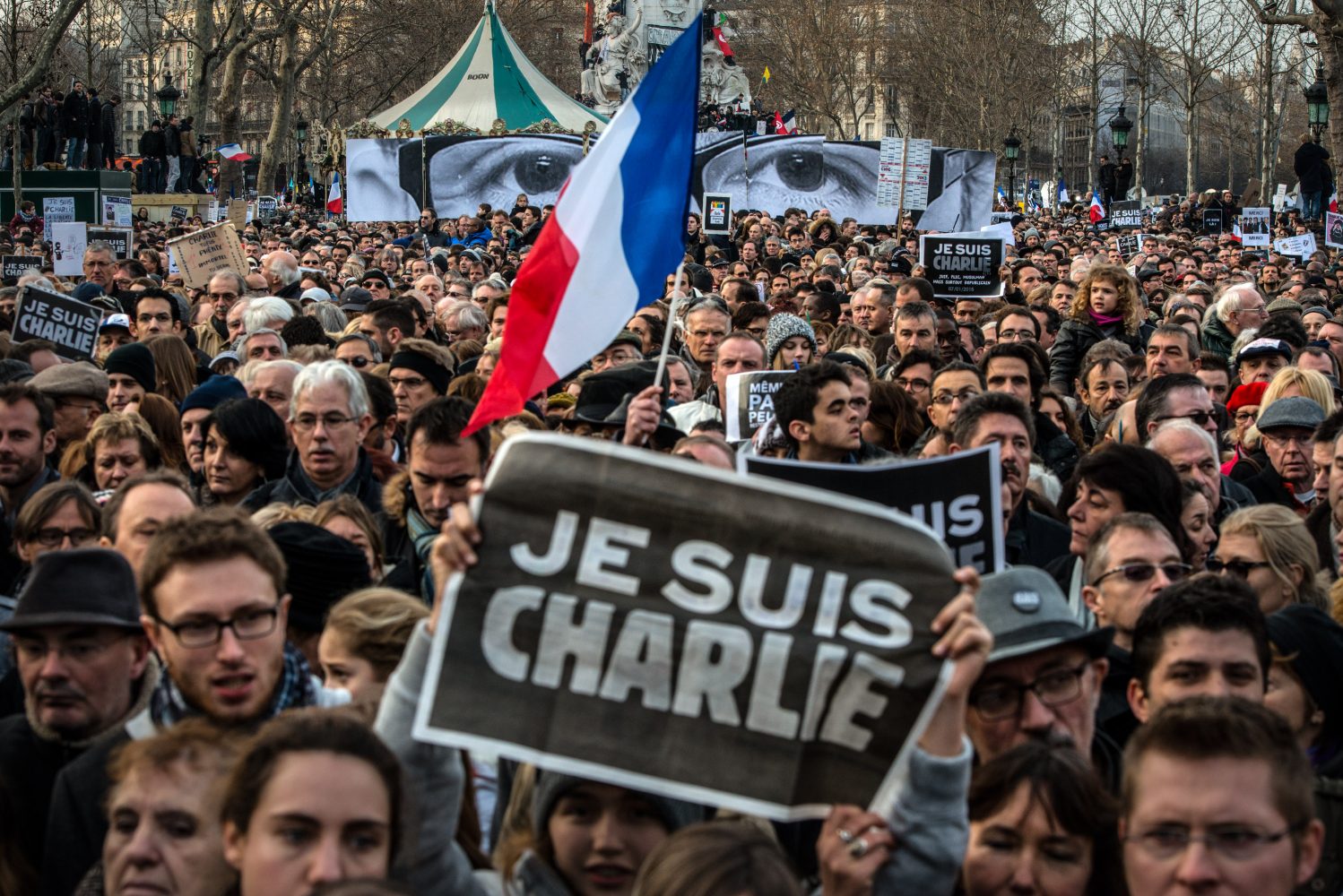 PARIS%2C+FRANCE+-+JANUARY+11%3A++Demonstrators+make+their+way+along+Place+de+la+Republique+during+a+mass+unity+rally+following+the+recent+terrorist+attacks+on+January+11%2C+2015+in+Paris%2C+France.+An+estimated+one+million+people+have+converged+in+central+Paris+for+the+Unity+March+joining+in+solidarity+with+the+17+victims+of+this+weeks+terrorist+attacks+in+the+country.+French+President+Francois+Hollande+led+the+march+and+was+joined+by+world+leaders+in+a+sign+of+unity.+The+terrorist+atrocities+started+on+Wednesday+with+the+attack+on+the+French+satirical+magazine+Charlie+Hebdo%2C+killing+12%2C+and+ended+on+Friday+with+sieges+at+a+printing+company+in+Dammartin+en+Goele+and+a+Kosher+supermarket+in+Paris+with+four+hostages+and+three+suspects+being+killed.+A+fourth+suspect%2C+Hayat+Boumeddiene%2C+26%2C+escaped+and+is+wanted+in+connection+with+the+murder+of+a+policewoman.++%28Photo+by+David+Ramos%2FGetty+Images%29+ORG+XMIT%3A+531669519+ORIG+FILE+ID%3A+461341606